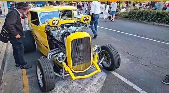 Yellow blown street rod with twin superchargers